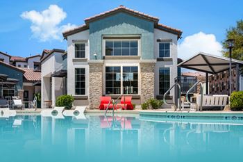 A large house with a pool in front.